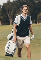 Man holding a golf bag on a golf course