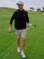 Man on a golf course holding a golf club