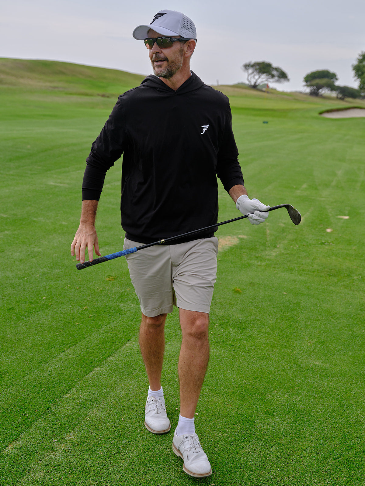 Man on a golf course holding a golf club