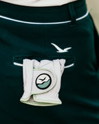 The Linksy women's golf glove tucked into the back pocket of the Linksy Stella golf shorts—effortlessly stylish and course-ready.
