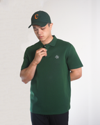 Man wearing green polo shirt in white studio setting
