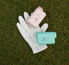 White golf glove with pink and green women on par rangefinders on grass